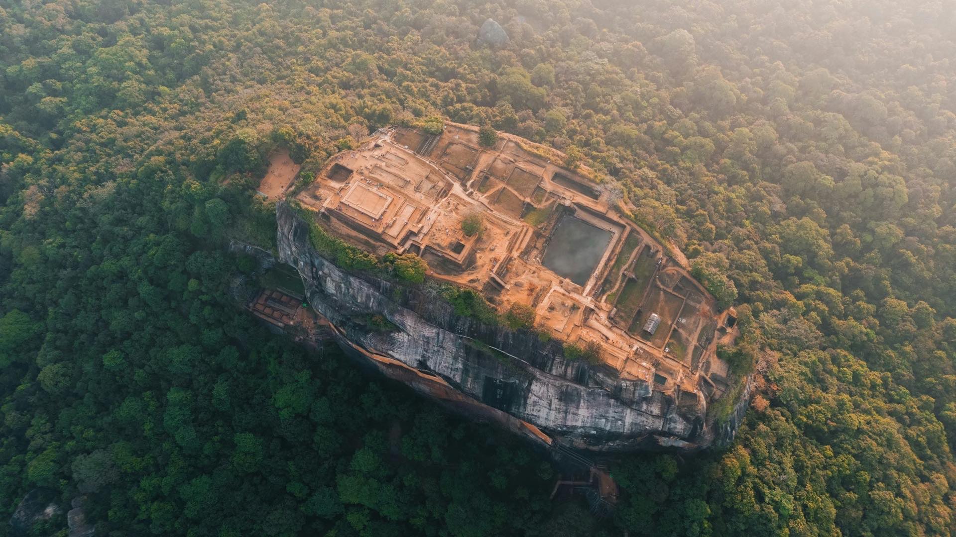 Aerial view of the ruined summit palace on Sigiriya rock fortress surrounded by forest